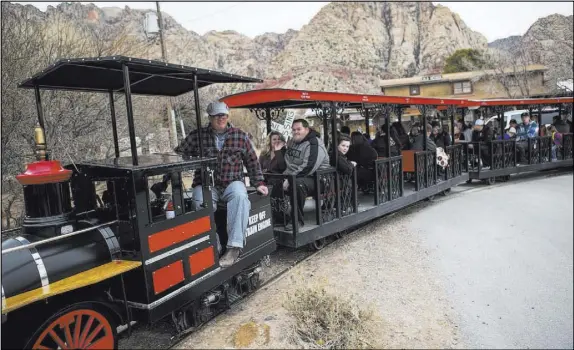  ?? Chase Stevens Las Vegas Review-Journal @csstevensp­hoto ?? Visitors enjoy a train ride Saturday at Bonnie Springs Ranch outside of Las Vegas. The ranch is under contract to be sold and demolished for luxury home lots.