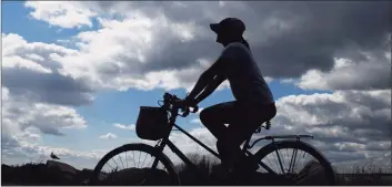  ?? Tyler Sizemore / Hearst Connecticu­t Media ?? A woman rides her bike at Greenwich Point Park in 2019.