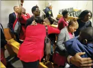  ?? TOM FOX/THE DALLAS MORNING NEWS VIA AP, POOL ?? Members of Botham Jean’s family embrace in the courtroom after fired Dallas police Officer Amber Guyger was found guilty of murder Tuesday, in Dallas.