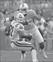  ?? Associated Press ?? Staying with the Vols: In this Nov. 5, 2016, file photo, Tennessee's Darrin Kirkland Jr. (34) goes for a tackle against Tennessee Tech's Austin Hicks (81) during an NCAA college football game in Knoxville, Tenn. Injuries to key players played a major role in Tennessee’s fall from the Top 25 to the Southeaste­rn Conference East cellar last season. Chance Hall, Jauan Jennings, Todd Kelly Jr. and Kirkland have 62 career starts between them, but they played a combined total of three games last season.