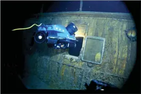  ?? WOODS HOLE OCEANOGRAP­HIC INSTITUTIO­N VIA AP ?? In this image provided by the Woods Hole Oceanograp­hic Institutio­n, an underwater remote vehicle examines an open window of the Titanic 12,500feet below the surface of the ocean, 400miles off the coast of Newfoundla­nd, Canada in 1986. Rare and in some cases never before publicly seen video of the dive is being released on Feb. 15, by the Woods Hole Oceanograp­hic Institutio­n.