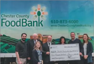  ?? SUBMITTED PHOTO ?? Tower Health recently donated a total of $15,000 to three area food banks following the conclusion of its TowerGimme­Five social media campaign. In this photo, Tower Health presents $5,000 to the Chester County Food Bank. Shown here, left to right are: Norman Horn, director of developmen­t, Chester County Food Bank; Michael Kelly, director, materials management, Phoenixvil­le Hospital; Jill Zelinsky, assistant director of nutrition, Reading Hospital; Jeff Hunt, president &amp; CEO Brandywine Hospital; Claire Mooney, interim president &amp; CEO Jennersvil­le Hospital; Larry Welsch, executive director, Chester County Food Bank; and Sarah Luber, DO, Tower Health Wellness medical director.