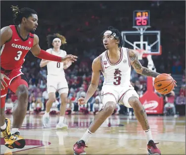  ?? Charlie Kaijo/NWA Democrat-Gazette ?? Hogs hit road: Arkansas guard Nick Smith Jr. (3) handles the ball Tuesday during the second half of a basketball game at Bud Walton Arena in Fayettevil­le. The Razorbacks play at Alabama today in an SEC showdown.