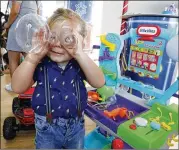  ?? RICHARD DREW / AP ?? Hutton, 3, plays with Little Tikes Circuit Center at the Walmart Toy Shop event. Walmart says 30 percent of its holiday toy assortment will be new.