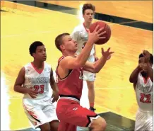  ?? File-LARRY GREESON / For the Calhoun Times ?? Sonoravill­e’s Brad Wilson (center) goes up for a shot during a game earlier this season.