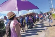  ?? MICHAEL ROBINSON CHAVEZ/THE WASHINGTON POST ?? People purchase ice after waiting in line for three hours in Utuado, Puerto Rico, last week. The ice cost $1.50 a bag and sales were limited to one bag per person.