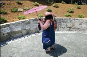  ?? AP PHOTO/STEPHAN SAVOIA, FILE ?? FILE - In this July 19, 2017, file photograph, Karla Hailer, a fifth-grade teacher from Scituate, Mass., shoots a video where a memorial stands at the site in Salem, Mass., where five women, including Elizabeth Johnson Jr., were hanged as witches more than 325years earlier. In 2021, Massachuse­tts lawmakers formally exonerated Elizabeth Johnson Jr. 329years after she was convicted of witchcraft in 1693and sentenced to death at the height of the Salem Witch Trials. Johnson is believed to be the last accused Salem witch to have her conviction set aside by legislator­s.