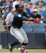  ?? Lynne Sladky ?? The Associated Press Atlanta Braves rookie Ronald Acuna Jr., hitting a homer in a spring training game against the Yankees, got his first big-league start Wednesday against the Reds.