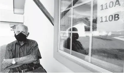  ?? MIGUEL ROBERTS/AP ?? Seventy-year-old Jacobo Garcia visits Aurora Garcia, his wife of 54 years, at her bedside window outside her nursing home in Brownsvill­e, Texas, in August 2020.