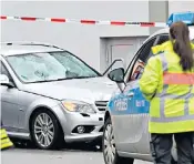  ??  ?? The scene after a car ploughed into a carnival parade in Volksmaren, left; above, police guard a Mercedes estate car. Below left, forensics officers at work last night