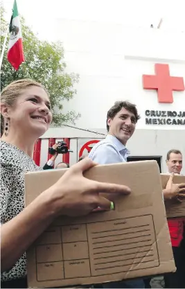  ?? SEAN KILPATRICK / THE CANADIAN PRESS ?? Prime Minister Justin Trudeau and wife Sophie Grégoire Trudeau help with earthquake relief at the Red Cross in Mexico City on Thursday.