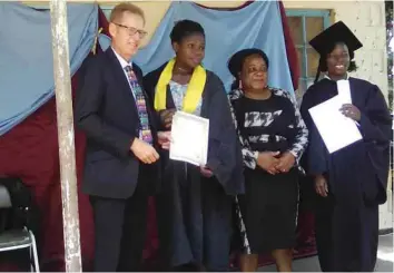  ??  ?? ZCDC Chief Operating Officer Mr Roberto de Pretto, hands over a garment making certificat­e to Miss Kalonde at Chipinge College of Horticultu­re, recently. Looking on are Mrs Ngadziore and the college principal Mrs Melody Gapara.