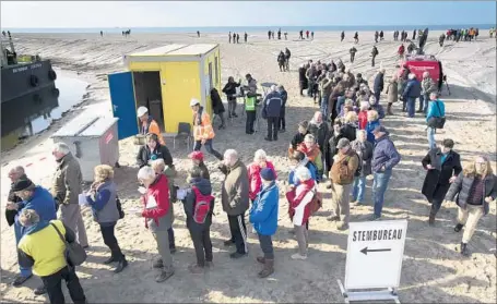  ?? Koen Suyk European Pressphoto Agency ?? VOTERS wait to cast their ballots in the Netherland­s’ parliament­ary elections. The vote is the first of three key elections in Europe — ahead of those in France and Germany — with observers waiting to see whether the continent will swing right.