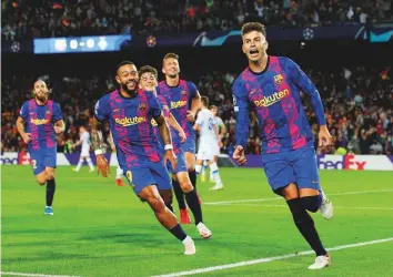  ?? Reuters ?? Barcelona’s Gerard Pique celebrates after scoring against Dynamo Kyiv during the Champions League Group E match at Camp Nou yesterday.
