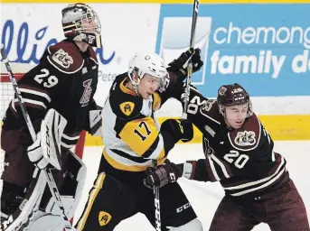  ?? CLIFFORD SKARSTEDT EXAMINER FILE PHOTO ?? Peterborou­gh Petes defenceman Declan Chisholm (20) squares off against Hamilton Bulldogs’ Brandon Saigeon during OHL action in 2018 at the Memorial Centre. Chisholm shows a commitment to getting better that impressed the Winnipeg Jets, who inked him to a three-year entry-level contract Monday.