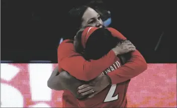  ?? MORRY GASH/AP ?? ARIZONA HEAD COACH ADIA BARNES gets a hug from guard Aari McDonald (2) at the end of a women’s Final Four NCAA college basketball tournament semifinal game against Connecticu­t Friday at the Alamodome in San Antonio.