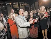  ?? ST. JOHN PROPERTIES/WENDY HICKOK PHOTOGRAPH­Y ?? Employees react after St. John Properties surprised them with bonuses totaling $10 million Dec. 7 in Baltimore.