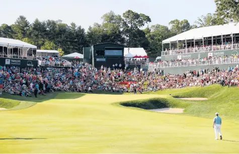  ?? ROB CARR/GETTY ?? A Travelers Championsh­ip signature moment: The would-be champion walking up the 18th fairway as a bowl full of fans awaits his arrival, just like Chez Reavie did in 2019. After a year of silence thanks to COVID-19, the 2021 would-be champion will get to experience the same thing come this Sunday.