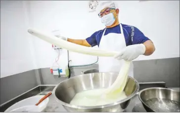  ?? HONG MENEA ?? Cheese-maker Vuthy at work in Phnom Penh’s Tuol Kork district on August 8.