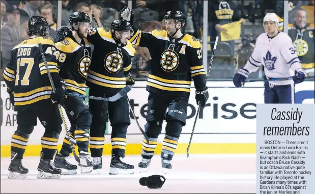  ?? THE ASSOCIATED PRESS ?? Maple Leafs centre Auston Matthews (background) looks on as the Bruins’ top line celebrates David Pastrnak’s hat trick on Saturday night in Boston. Pastrnak, Brad Marchand and Patrice Bergeron have combined for 20 points so far in the series.