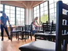  ?? EDDIE MOORE/JOURNAL ?? Ruth Lopez, left, and Catalina Quintana, a manager, work to get the Pantry’s new downtown location in Santa Fe ready for opening in early October.