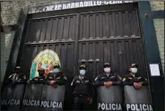  ?? (AP/Guadalupe Pardo) ?? Police guard the jail where former Peruvian President Alberto Fujimori is being held Tuesday in Lima, Peru.