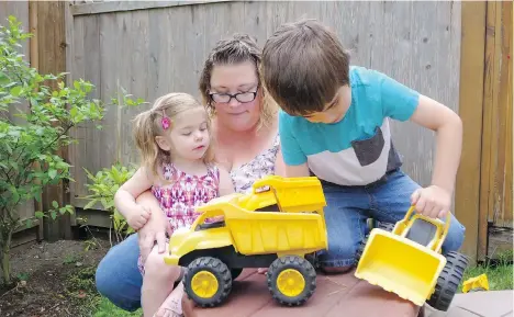  ?? JENNIFER SALTMAN/PNG ?? Susie Clark plays with daughter Karis and son Adam outside their Langley home. Clark says fee increases at the daycare facility her children attend are reducing the amount of money she could be saving through the provincial government’s Child Care Fee...