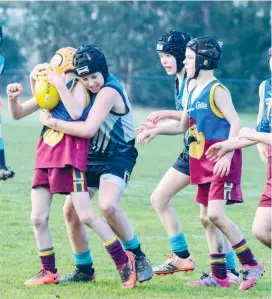  ??  ?? Colts player Chance Ross is wrapped up in a strong tackle by Yarragon opponent Jack Winduss; Photograph­s: Craig Johnson.