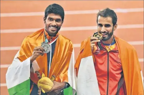  ?? AFP ?? India's Manjit Singh (right) and Jinson Johnson celebrate their 12 finish in men’s 800m event at the Asian Games on Tuesday.