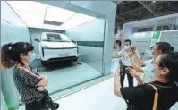  ?? LIN SHANCHUAN / XINHUA ?? Visitors learn about new energy vehicles’ battery-changing process at the booth of Contempora­ry Amperex Technology Co Ltd during an expo in Xiamen, Fujian province, in September.