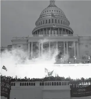  ?? REUTERS ?? An explosion caused by a police munition is seen while supporters of U.S. President Donald Trump gather in front of the U.S. Capitol Building in Washington on Wednesday.