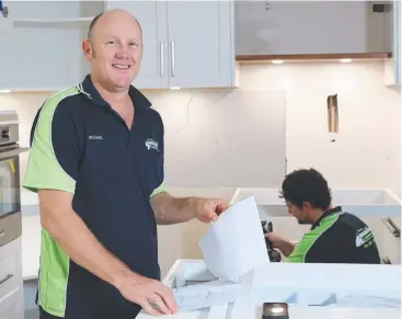  ?? Picture: MARC McCORMACK ?? KEEPING BUSY: Cairns Specialize­d Cabinets co-owner Michael Porta and a worker at one of the firm’s renovation job sites at Redlynch.