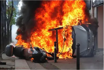  ??  ?? A car burns outside a Renault automobile garage during clashes at the May Day labour union march in Paris. — Reuters photo