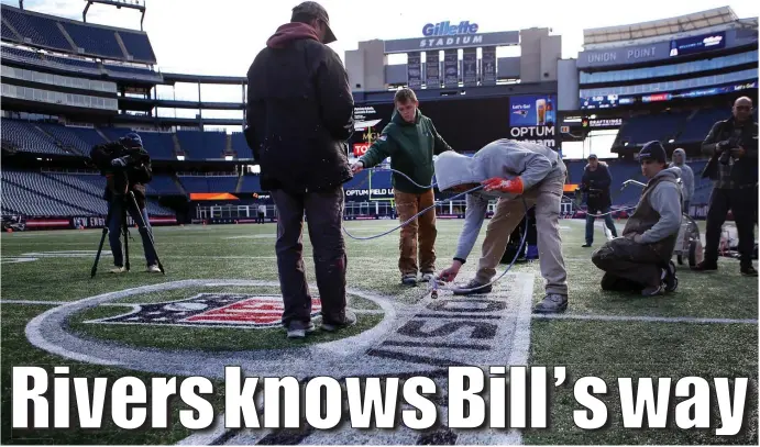  ?? NANCY LANE / BOSTON HERALD ?? FINAL TOUCHES: The Gillette Stadium field crew paints the divisional round logo on the turf ahead of Sunday’s game between the Patriots and Chargers.