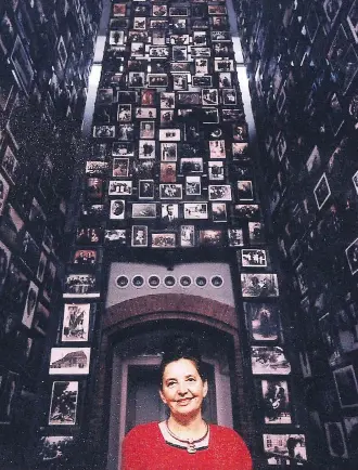  ?? YAFFA ELIACH SHTETL COLLECTION/THE ASSOCIATED PRESS ?? Yaffa Eliach stands amid her collection of photograph­s at the U.S. Holocaust Memorial Museum. As a professor, she helped build the field of Holocaust studies.