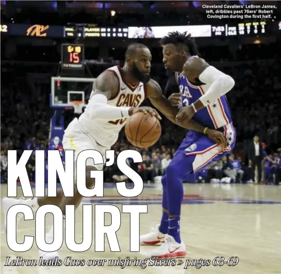  ?? THE ASSOCIATED PRESS ?? Cleveland Cavaliers’ LeBron James, left, dribbles past 76ers’ Robert Covington during the first half.