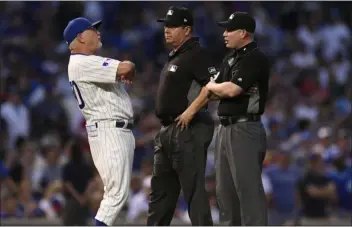  ?? THE ASSOCIATED PRESS FILE ?? In Chicago, like on the mid-July evening at Wrigley Field pictured above, Cubs manager Joe Maddon, left, can relax and chat up some old umpire friends. On the road, however, Maddon would have more a reason to feel uncomforta­ble.