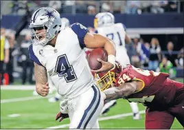  ?? [MICHAEL AINSWORTH/THE ASSOCIATED PRESS] ?? Dallas quarterbac­k Dak Prescott escapes pressure from Washington linebacker Preston Smith in the first half Thursday night in Arlington, Texas. Prescott suffered a hand injury in the second quarter but went on to lead the Cowboys to a 38-14 win.