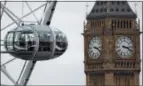  ?? FRANK AUGSTEIN — THE ASSOCIATED PRESS FILE ?? Visitors enjoy the London Eye ride beside The Elizabeth Tower housing the Big Ben bell on a cloudy day in London. Europe never seems to lose its appeal to American travelers, and the growth of discount airlines and alternativ­es to expensive hotels make...