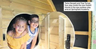  ??  ?? Twins Nevaeh and Trae Turner, four, play inside the new Hobbit House in the new outdoor play area at Springfiel­d Academy