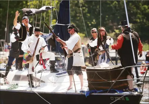  ?? Brian A. Pounds / Hearst Connecticu­t Media file photo ?? A boat full of ‘pirates’ arrive at Lisman Landing for Milford’s annual Pirates Day event in June 2021. This year’s Pirates Day is set for June 5.