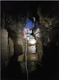  ?? (Special to the Arkansas Democrat-Gazette) ?? Ryan Spotts descends into a newly explored cave last year at Devil’s Knob Natural Area to map and inventory the cave with the help of the Cave Research Foundation. Spotts is the land management specialist/volunteer coordinato­r for the Natural Heritage Commission.