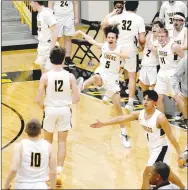  ?? MARK HUMPHREY ENTERPRISE-LEADER ?? Prairie Grove bench players congratula­te players coming off the floor in the aftermath of the Tigers’ nail-biting 45-43 win over Huntsville in boys basketball action on Tuesday, Jan. 19.