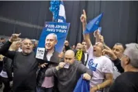  ?? DAN BALILTY/THE NEW YORK TIMES ?? Supporters of Israeli Prime Minister Benjamin Netanyahu celebrate his apparent election in Israel on Monday.