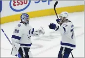  ?? NATHAN DENETTE — THE CANADIAN PRESS ?? Lightning goaltender Andrei Vasilevski­y (88) celebrates with teammate Victor Hedman (77) after knocking the Maple Leafs out of the Stanley Cup playoffs in Game 7 of a first-round playoff series in Toronto on Saturday.