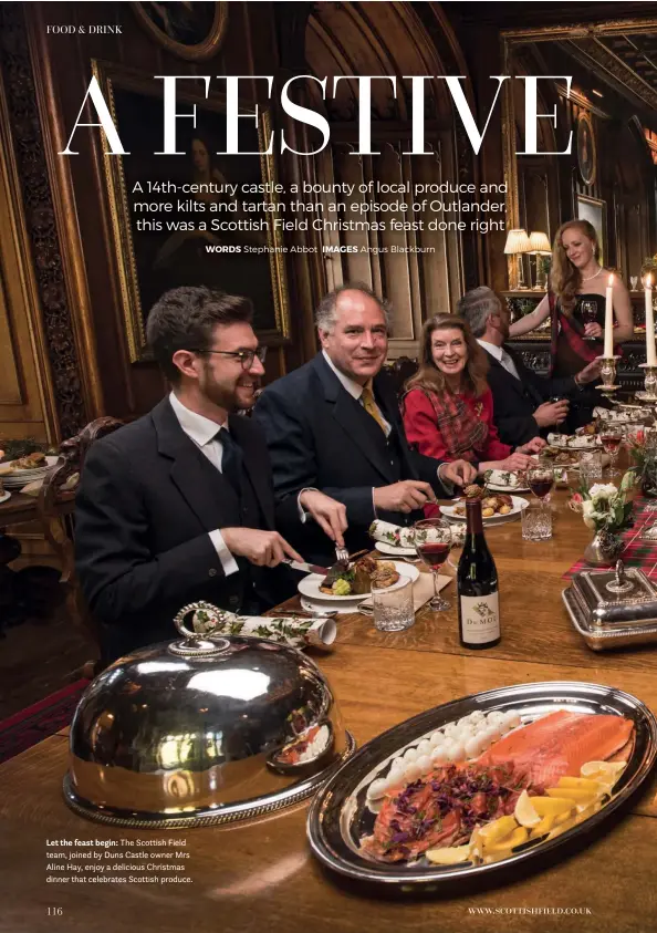  ??  ?? Let the feast begin: The Scottish Field team, joined by Duns Castle owner Mrs Aline Hay, enjoy a delicious Christmas dinner that celebrates Scottish produce.