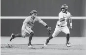  ?? SAM WOLFE Special To The State ?? Arkansas infielder Peyton Stovall chases down South Carolina outfielder Austin Brinling, who was caught in a rundown during the Gamecocks’ game against Arkansas at Founders Park in Columbia on Friday, April 19, 2024.