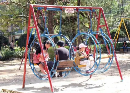  ?? Photo by Redjie Melvic Cawis ?? FOR ADULTS TOO. Despite the signage for the playground exclusivel­y for children, older people still use the equipment at the Childrens Park which leads to its dilapidati­on.