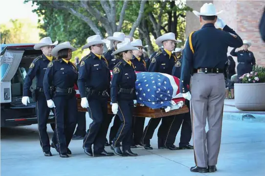  ?? Steve Gonzales / Houston Chronicle ?? The body of Harris County assistant chief deputy constable Clint Greenwood arrives at the Second Baptist Church on Thursday. Greenwood was killed Monday by a gunman who stepped out from behind a dumpster as Greenwood arrived for work.