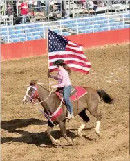  ?? Photo submitted ?? Emily Myers, of Siloam Springs, rides with the American Flag at a previous rodeo event.